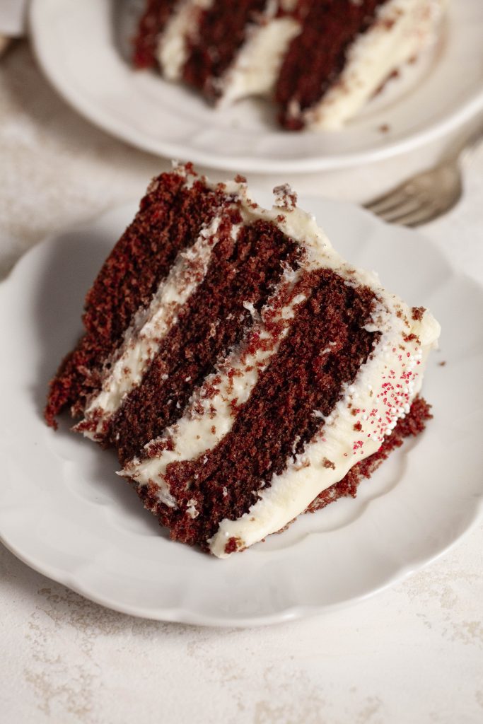 a slice of red velvet cake using natural food dye, on a plate. 